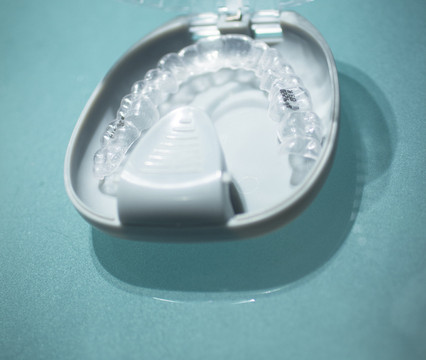 Invisible dental teeth brackets tooth plastic braces and case photo.